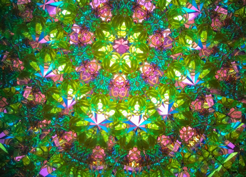 Green and pink interior of a kaleidoscope. Illusion. Glamour